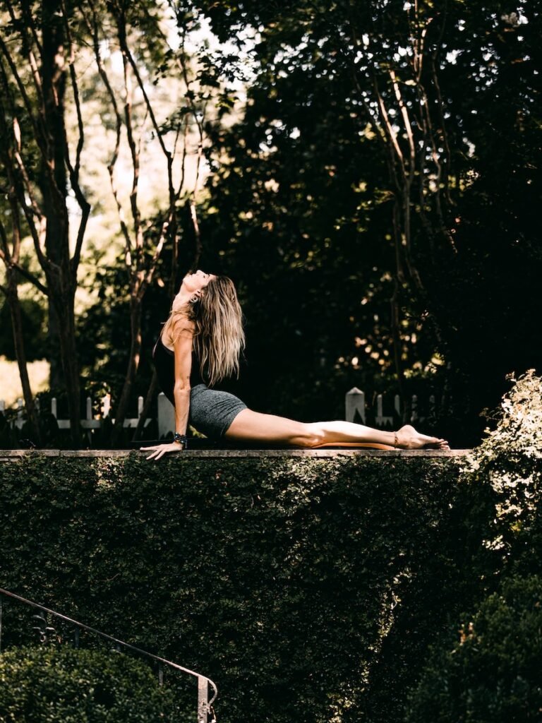 woman in black tank top and black shorts in the yoga cobra pose