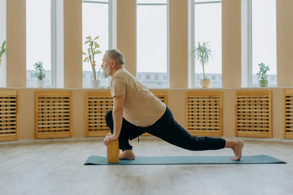 A man doing restorative yoga using wooden blocks