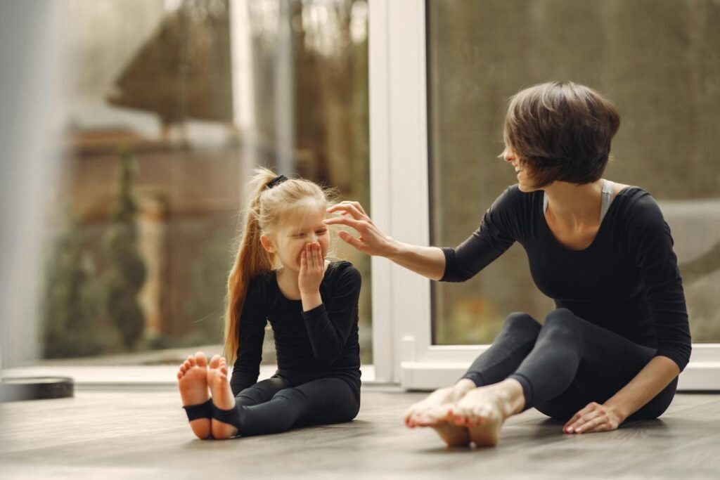 Mother anddaughter bonding during yoga pose for kids