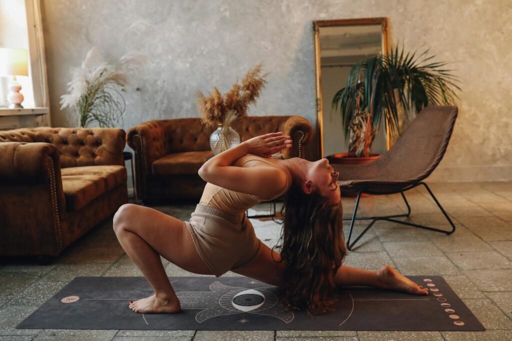 A woman in her living room practicing some easy yoga poses on a yoga mat