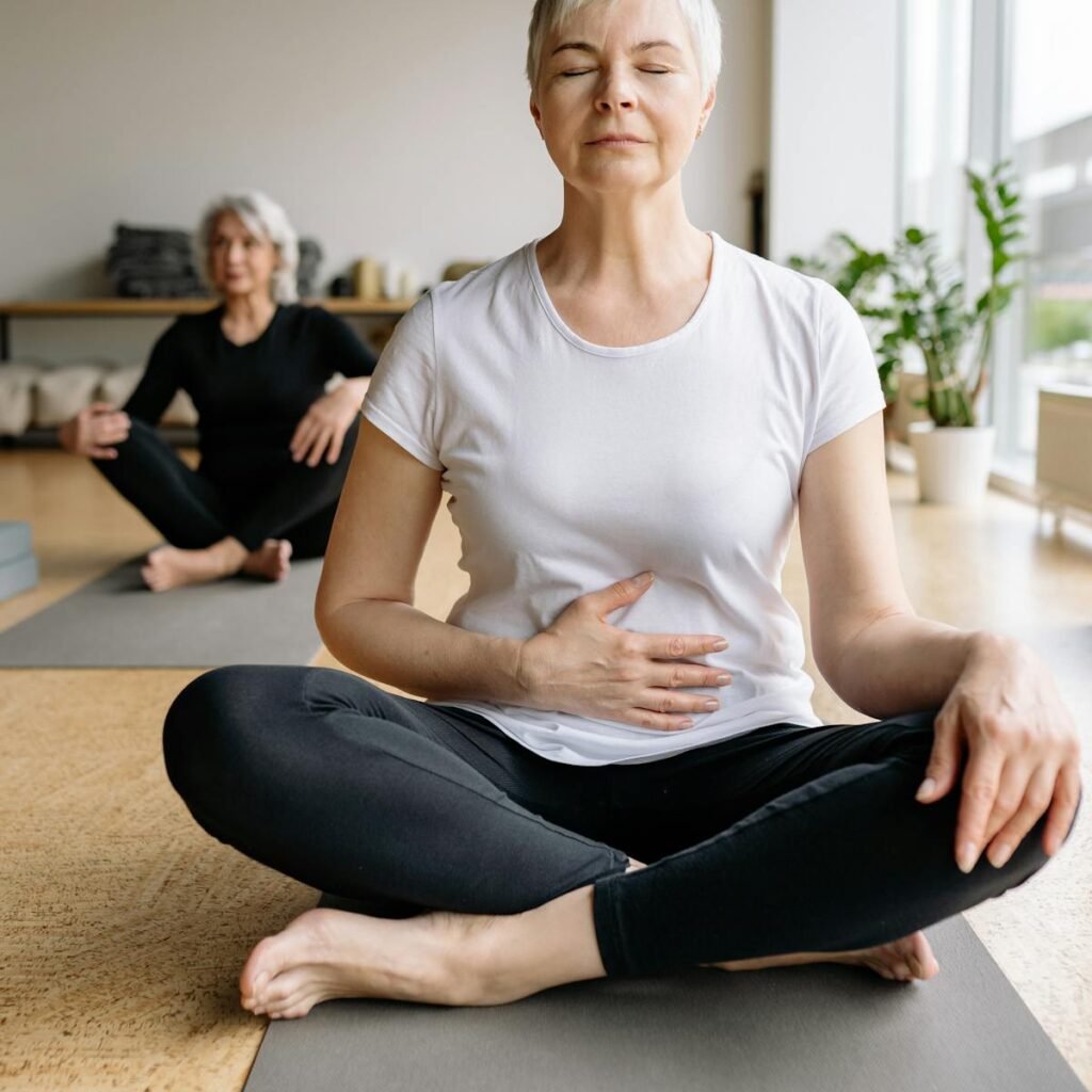 A woman sitting with her eyes closed, accepting the amazing benefits of yoga