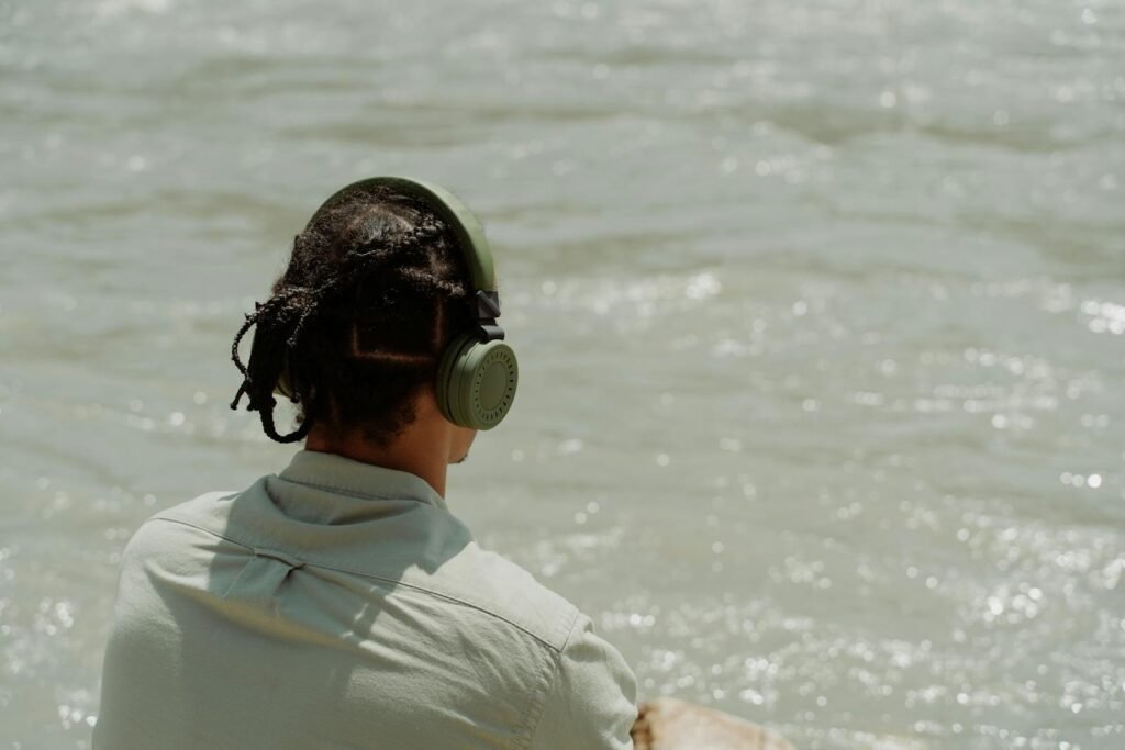 A man with braided hair listening to how meditation music can improve focus